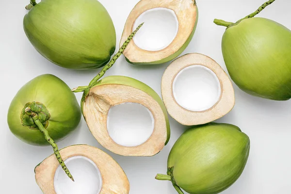 Fresh young coconuts on a white background, creative flat lay healthy food concept