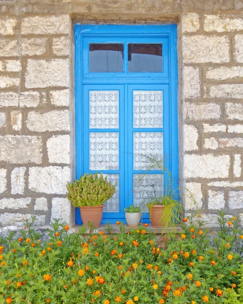 ギリシャでは 石の壁の青い家のウィンドウとマリーゴールドの花 — ストック写真