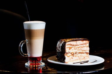 Çikolatalı kek ve kahve şurubu ile kafe, siyah arka plan, lezzetli yiyecek fotoğraf ahşap bir masa servis