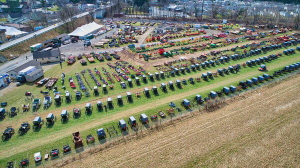 Aerial View of an Amish Mud Sale with Lots of Buggies and Farm Equipment
