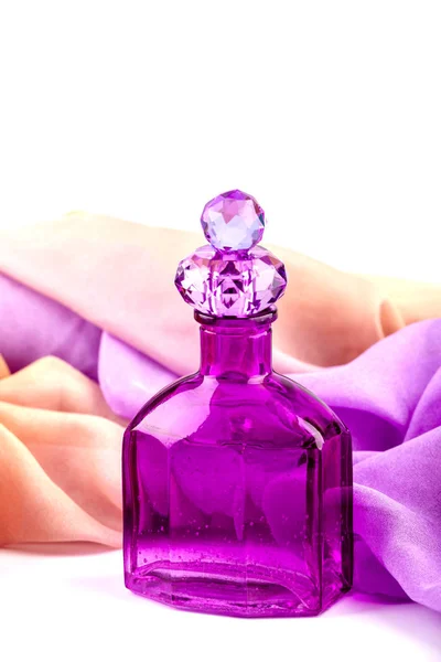 Purple vintage perfume bottle isolated on white background.