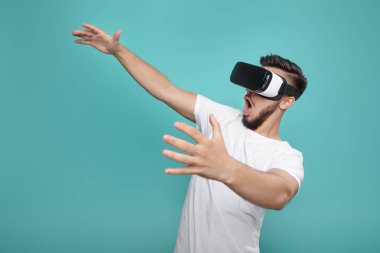 VR kulaklık çalışıyor ve renkli arka plan üzerinde başka bir dünya keşfetmek sakallı yakışıklı.