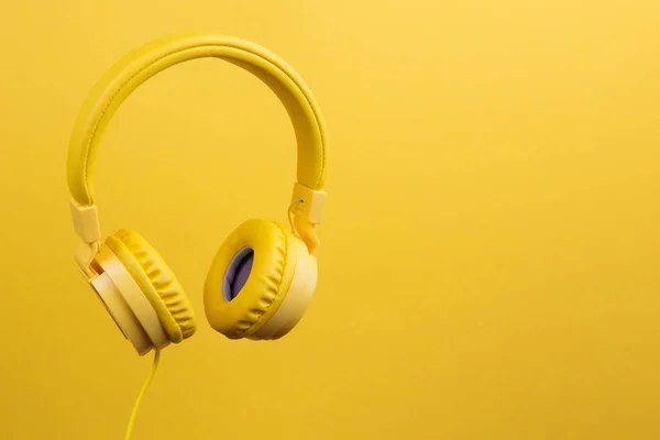 Auriculares amarillos sobre fondo amarillo. Concepto musical . —  Fotos de Stock