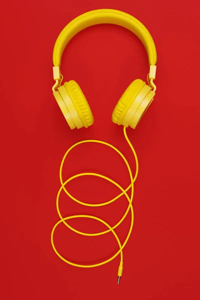 Yellow headphones on red background. Music concept. — Stock Photo, Image