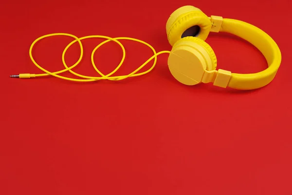 Yellow headphones on red background. Music concept. — Stock Photo, Image