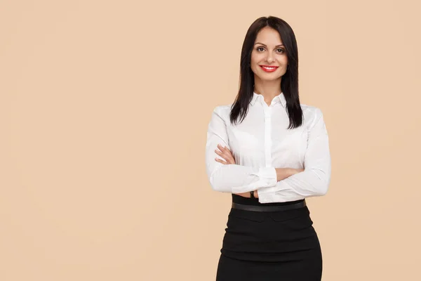 Charming young modern business woman standing over beige background. Success and winner concept. — Stock Photo, Image