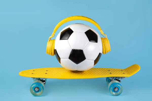 黄色耳机上的传统风格的足球在蓝色背景。音乐概念. — 图库照片