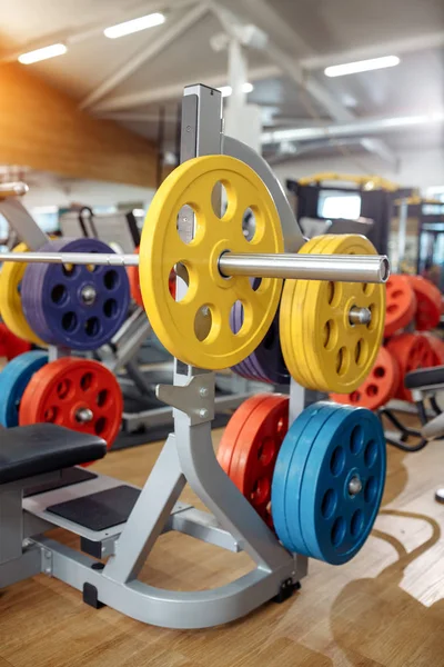 Photo of colorful weight bench with barbell in gym. sport, Fitness and bodybuilding concept.
