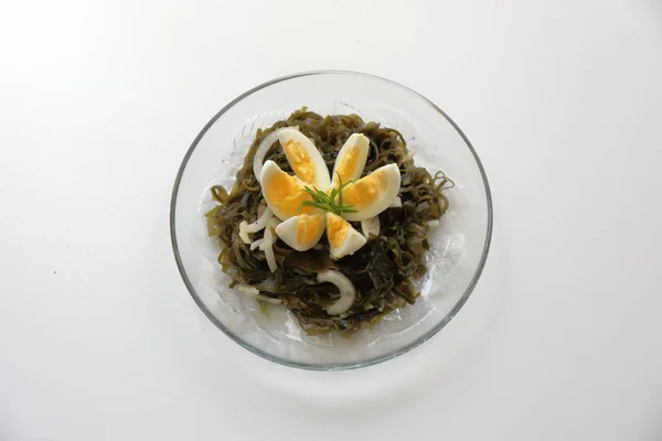 lezzetli lezzetli salata, haşlanmış yumurta ve soğan ile deniz kale.