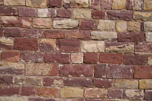 Antique brick walls of Hindu temples. Rectangular bricks, cut from red sandstone and bonded together with lime mortar.