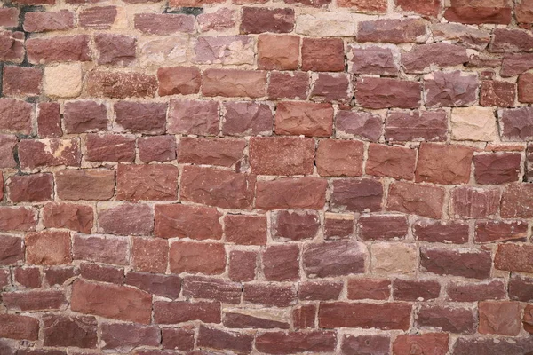 Antique brick walls of Hindu temples. Rectangular bricks, cut from red sandstone and bonded together with lime mortar.