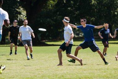 Man Slings Disc To Teammate In Atlanta Ultimate Frisbee Game clipart