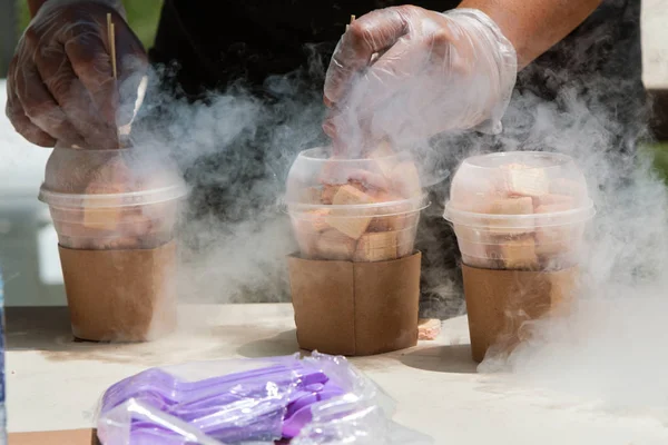 Liquid Nitrogen Steams As Man Prepares Frozen Treats At Festival — Stock Photo, Image