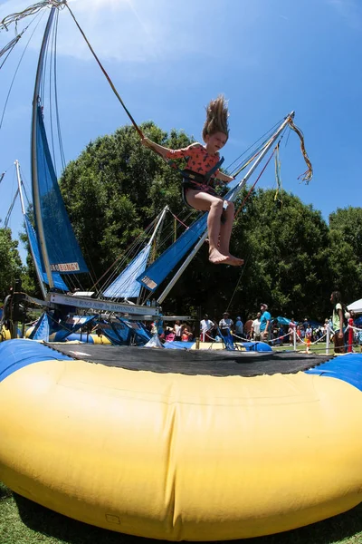 Girl Gets Airborne Bouncing On Bungee Trampoline At Atlanta Festival — Stock Photo, Image