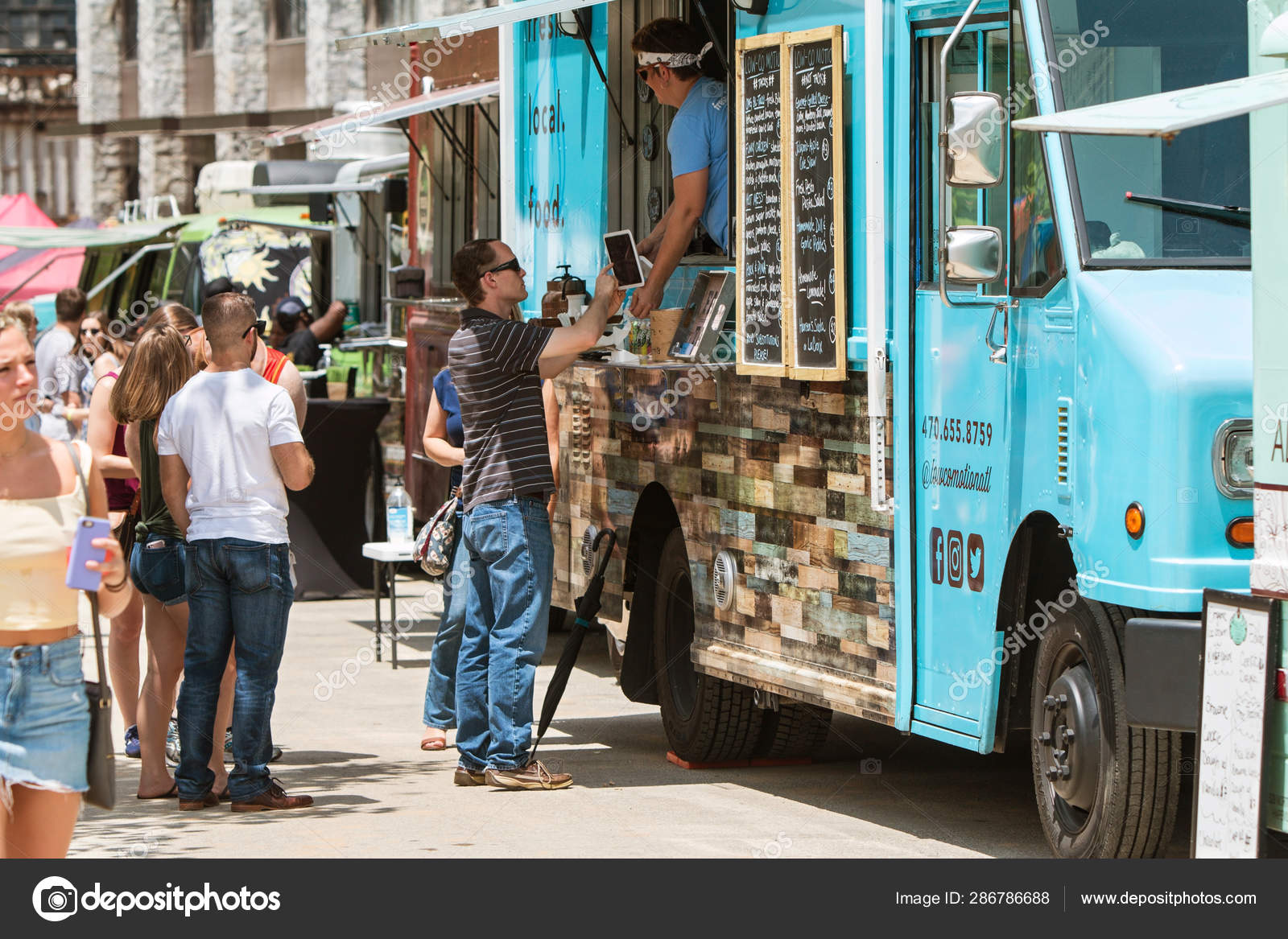 Man Buys Food At Old Fourth Ward Food Truck Festival Stock