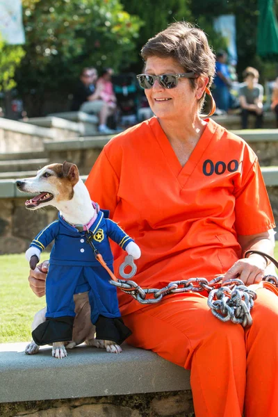 Dog Wearing Prison Guard Costume Is Chained To Female Owner — Stock Photo, Image