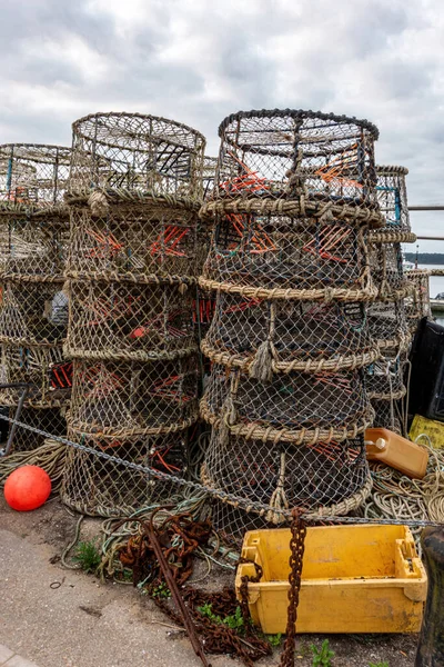 Crab trap baskets stacked on a quayside