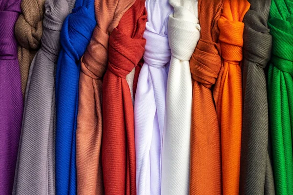 Pieces of fabric and textiles in a factory shop or store or bazar. Multi different colors and patterns on the market.