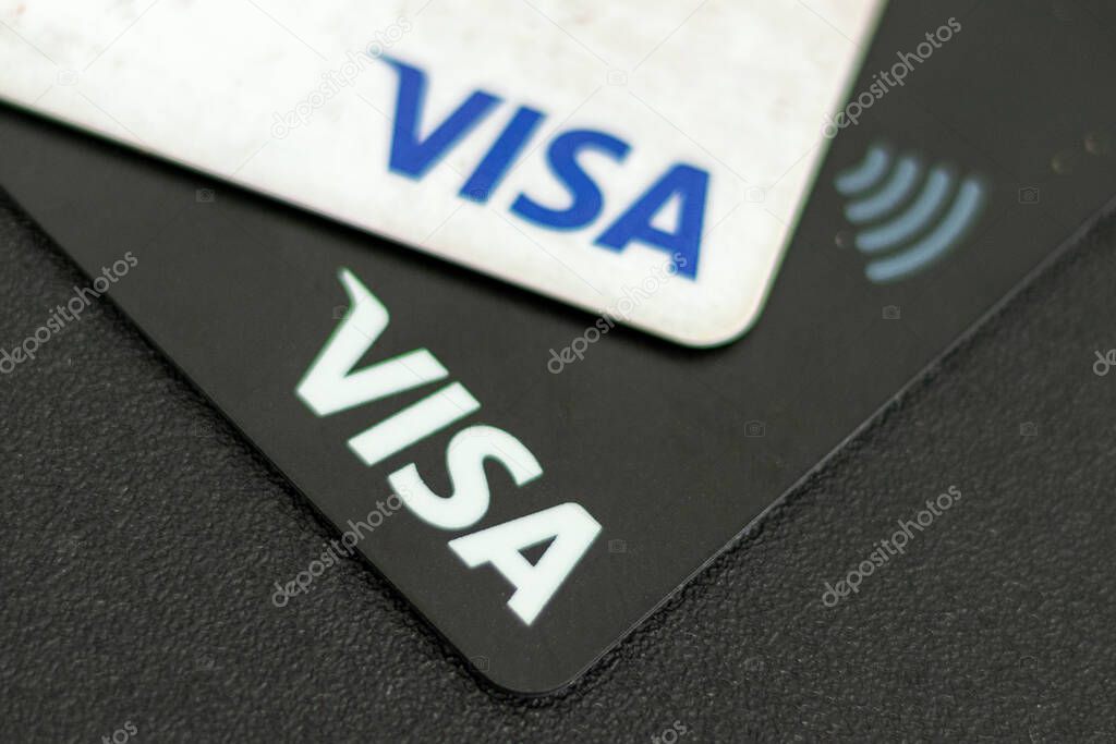 Lviv, Ukraine - June 16, 2020. Black and white credit cards Visa close up. Visa contactless payment cards closeup. Top view. Selective focus.
