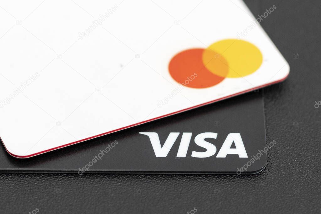 Lviv, Ukraine - June 16, 2020. Mastercard and Visa credit cards close up. Contactless payment cards closeup. Selective focus.