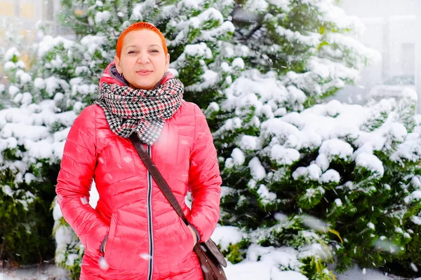 Girl at the Mall. Shopping and good mood. Buying Christmas gifts. Snow winter fairy tale.