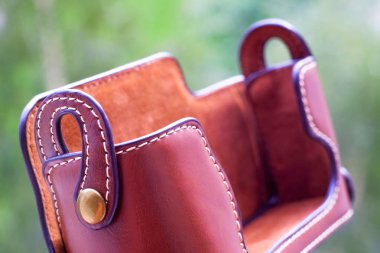 Kamera için durum. Yeşil zemin üzerine perçin ile deri çanta.