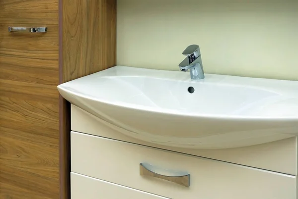Wash basin modern sink in the bathroom. Yellow water mixer.