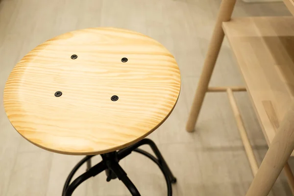 Wooden chair with screw lift. blurred kitchen background, bokeh.