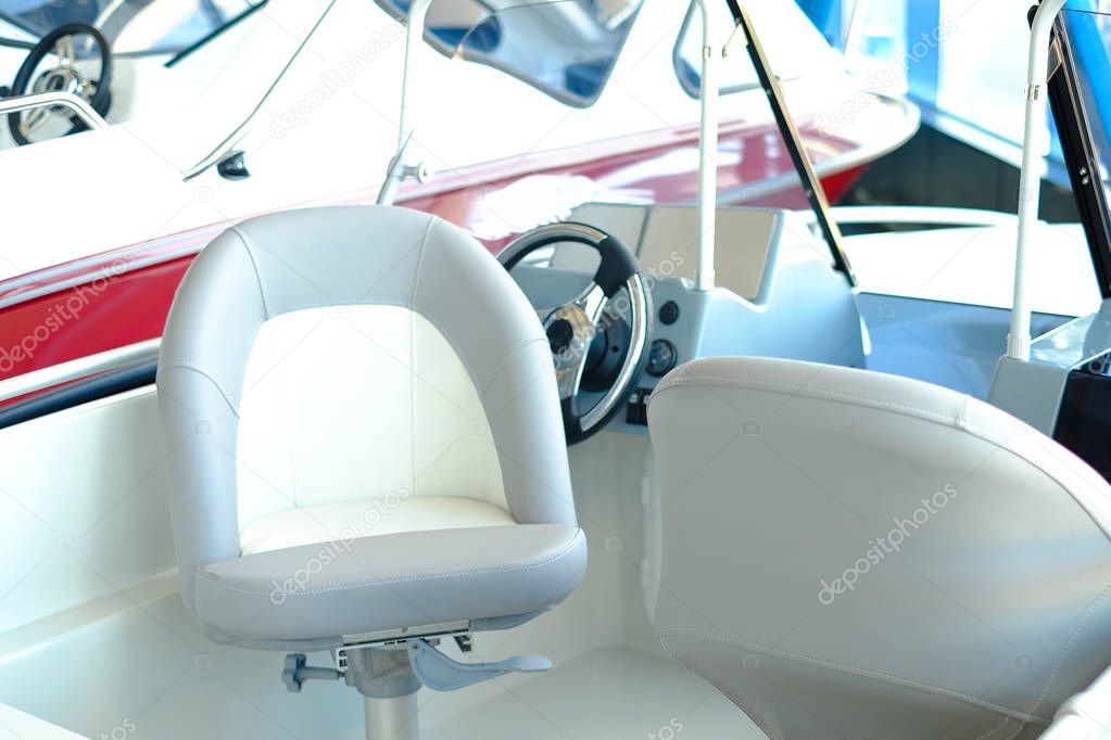 The cabin of the boat with an easy chair. Boat cabin with all navigation equipment