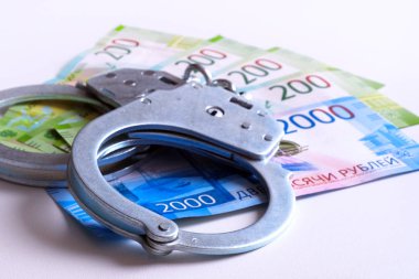 Kelepçe ve banknot. Rüşvet ve yolsuzluk kavramı.