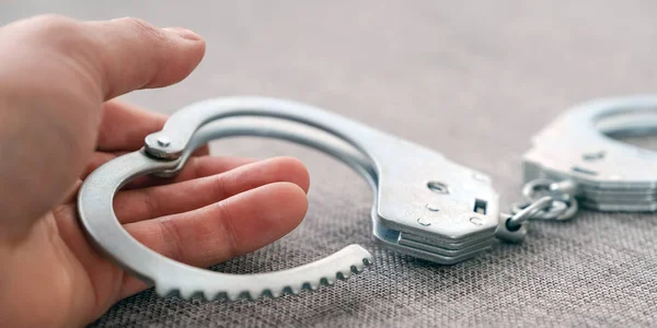 The cuffs on the table. Police unit. Close-up top view selective focus. — Stock Photo, Image