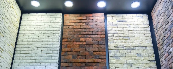 Stand images of decorative bricks. Bricks and aerated concrete blocks. White lightweight concrete block. Red brick. Building material.