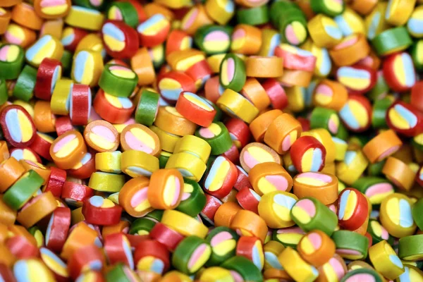 Colorful bright candy, children's joy. The composition of a variety of chocolates by weight in trays. — Stock Photo, Image