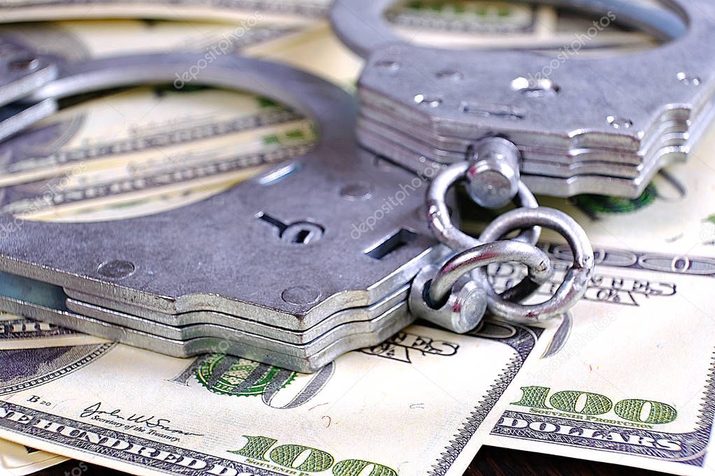 Handcuffs on a stack of money. Criminal earnings. Business concept. The concept of wealth.
