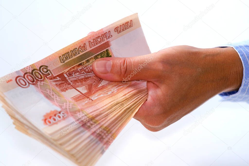 The financier holds a bundle of banknotes in his hand. Offering loans at interest and in installments.