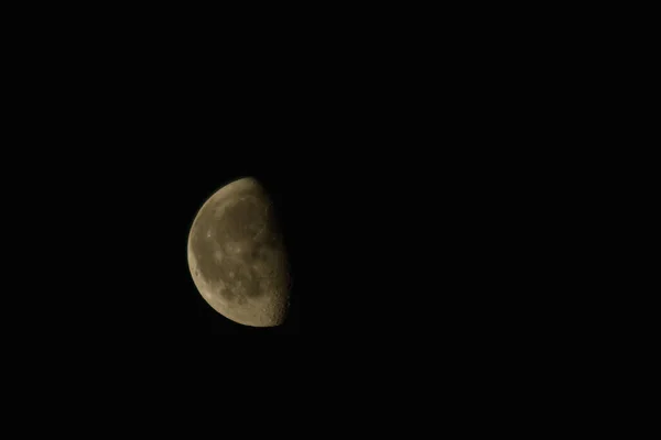 half the moon in the black sky