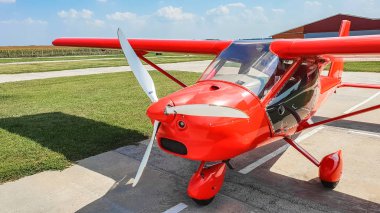 Pervanenin dönmesi ile basınçlandırdıktan bulutlu gökyüzü arka plan üzerinde kırmızı uçak görünümünü kapat