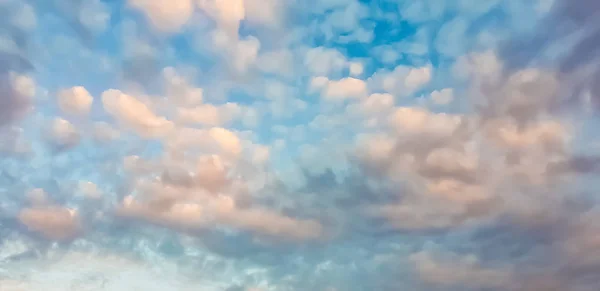 blue sky with white and gray clouds before rain