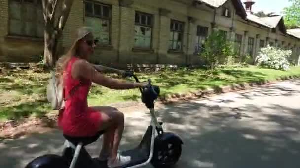 Handsome Young Blonde Woman Red Dress Backpack Smiling While Riding — Stock Video