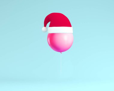 Mavi renk backgro üzerinde yüzen pembe balon ile Noel Baba şapka