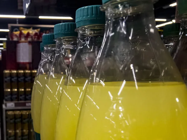 Bottles with yellow water on the shop window