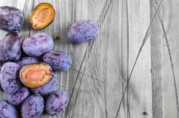 plum and dried plum on a wooden black and white background top view prunes