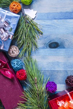 Mavi arkaplan üzerinde hediye paketi ve kozalaklı dallar Yeni yıl kopyalama alanı