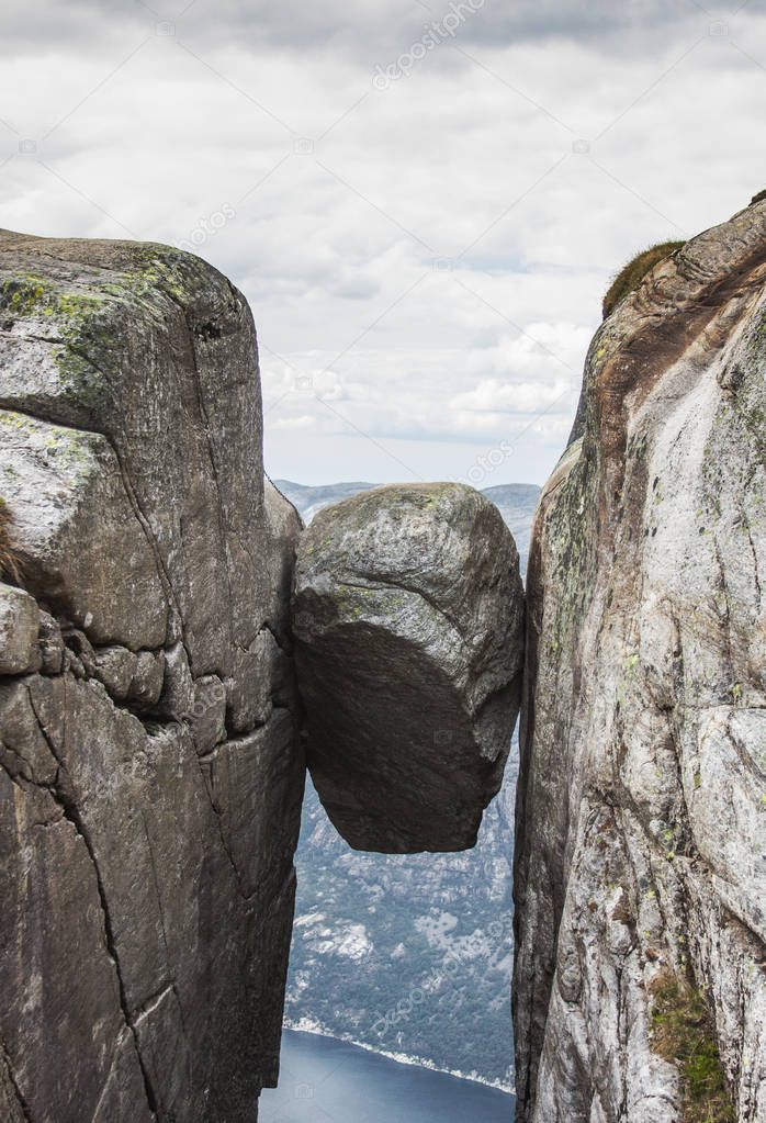 Famous Kjeragbolten boulder stuck between two granite cliffs on Kjerag mountain, Norway