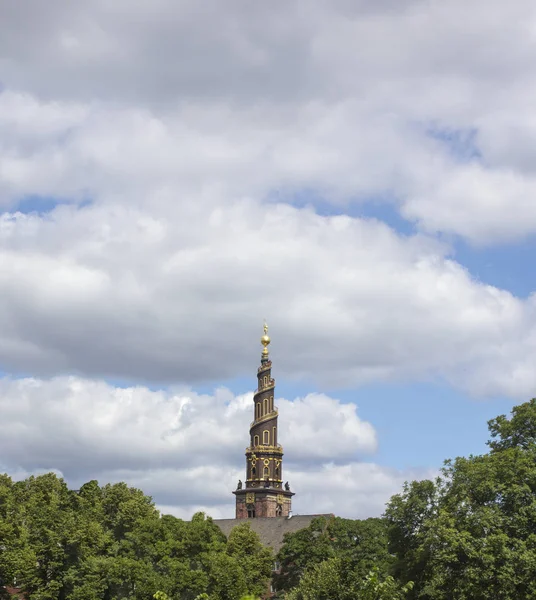 Dikey yönlendirmeli. Bulutların altında eski bir kilisenin Spire