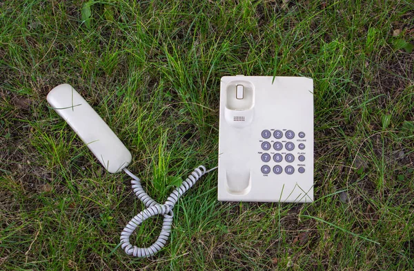 Communication with the earth. Allegory. A telephone with a receiver is located on a green lawn. Encourage discussion of human-induced environmental problems