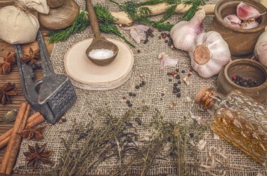 Sarımsak ampul, biber bezelye, tuz, yeşillik dereotu, Yıldız anason ve tarçın kahverengi ahşap masa arka plan üzerinde. Farklı baharatlar.