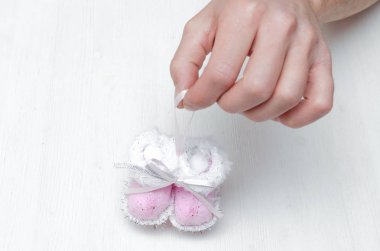 Yeni doğan bebek patik Noel oyuncak babası beyaz arka plan üzerinde eller.