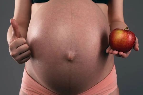 Pregnant Woman Holding Hand Red Apple Thumbs Gray Background — Stock Photo, Image