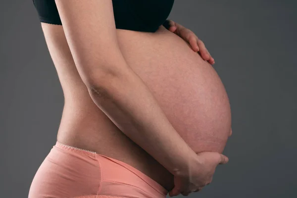 Young Pregnant Woman Holding Her Belly Her Hands Gray Background — Stock Photo, Image